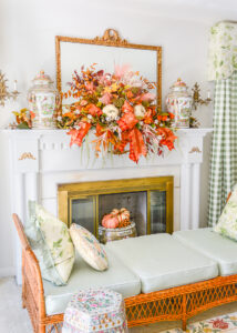 Fall mantel decor idea with sculptural garland full of autumn foliage and pumpkins