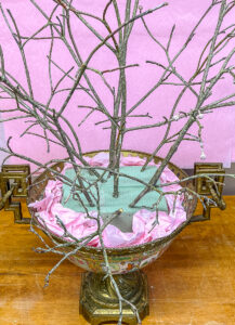 Fill pot with floral foam and tree branches to form base of gratitude tree