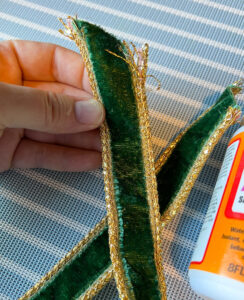 Detail view of frayed gold braiding on ribbon