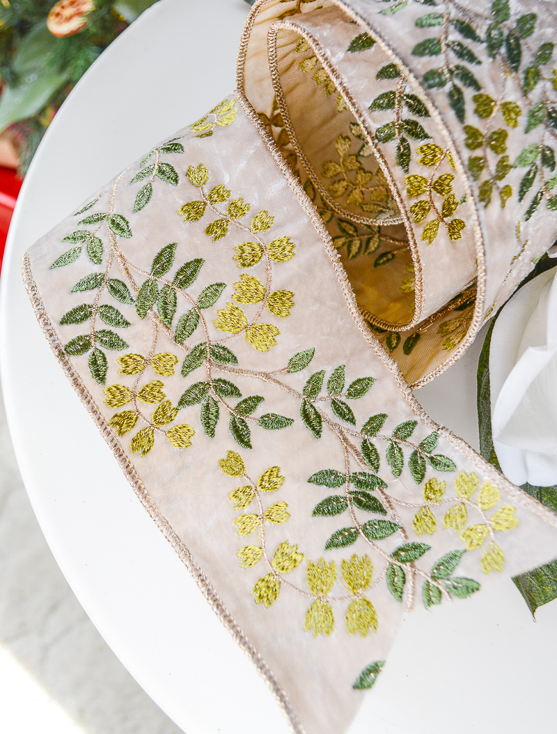 A lovely botanical vine ribbon with silver background and intertwined dark green and pale green vines.