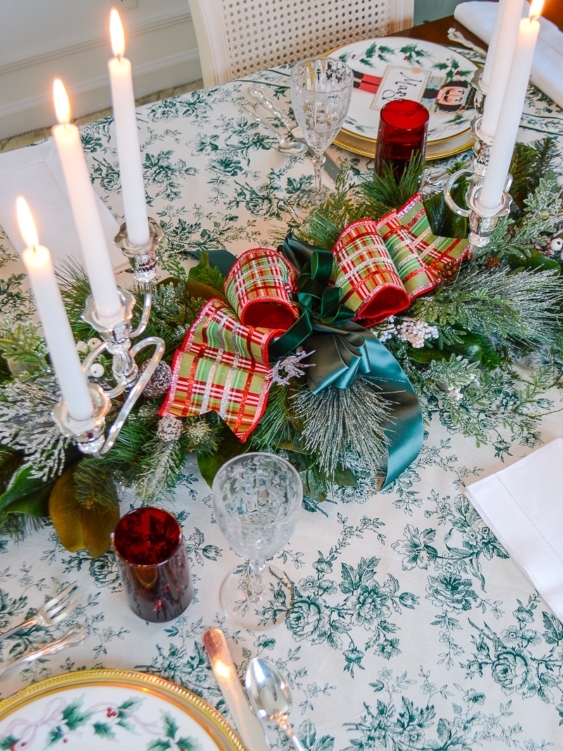 frosted winter pine swag with plaid glitter bow as Christmas centerpiece