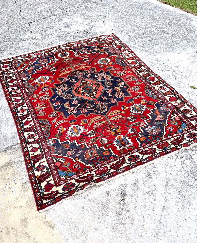 Red and blue Heriz style Persian rug before professional cleaning