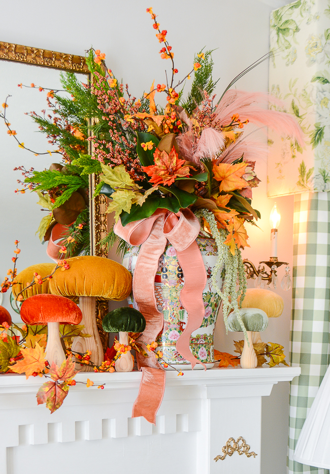 Fall floral arrangement in Rose Medallion temple jars with velvet mushrooms decorate this traditional mantel for fall