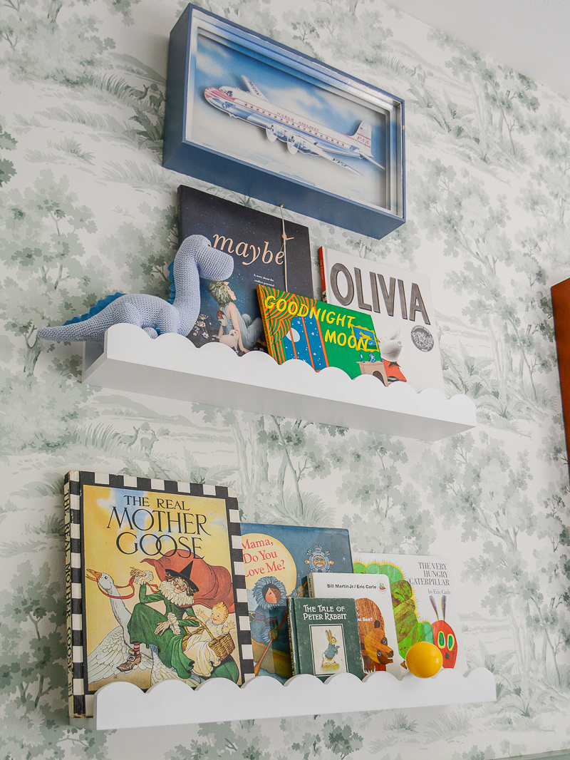 Scalloped wall shelves for books in boy's nursery