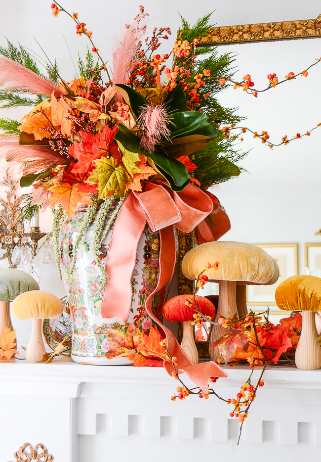 Fall floral arrangement in Rose Medallion temple jars with velvet mushrooms decorate this traditional mantel for fall