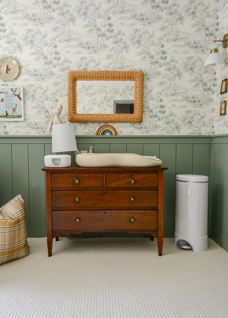 Antique dresser as changing table for boy's traditional nursery with woodland theme decor