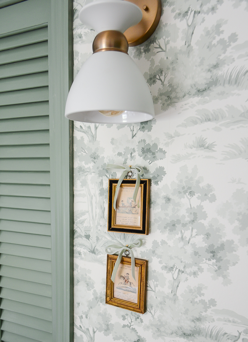 Practical lighting like this sconce on a dimmer switch is essential to designing a nursery