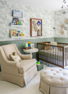 Tips for designing a nursery. Nursery rocker in green boy's nursery with woodland themed wallpaper and decor
