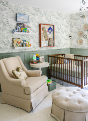 Tips for designing a nursery. Nursery rocker in green boy's nursery with woodland themed wallpaper and decor