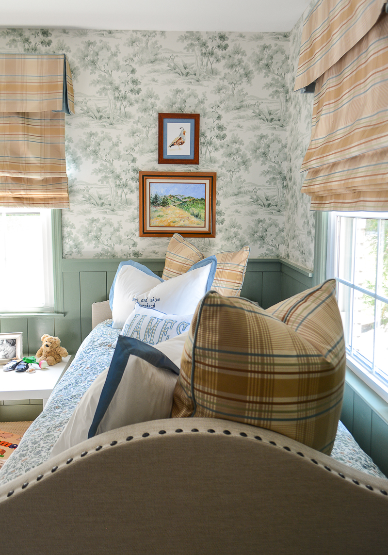 paintings in green woodland themed nursery