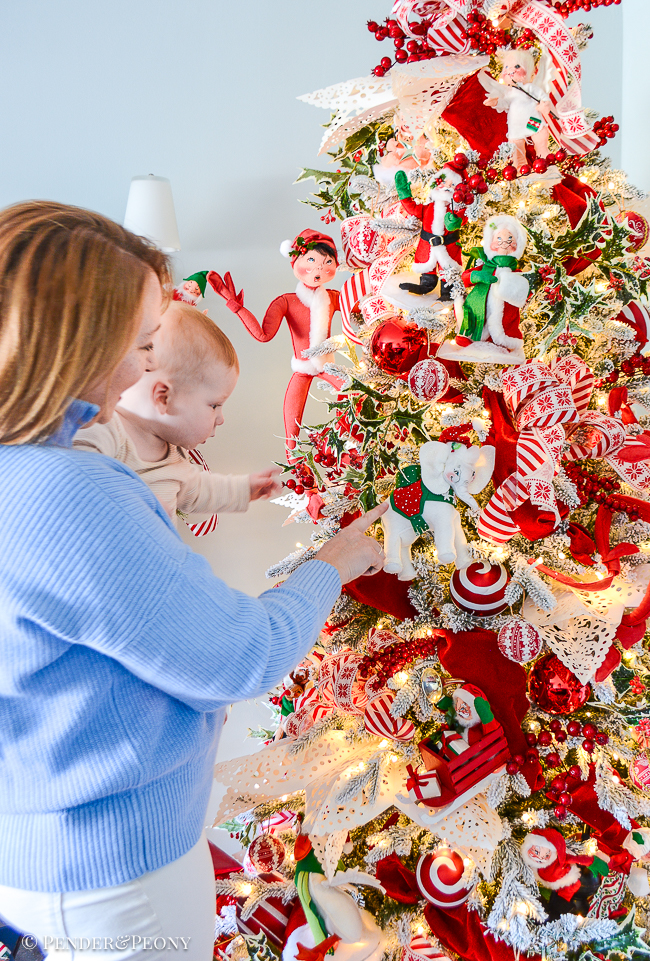 James and Katherine explore the red and white Christmas tree