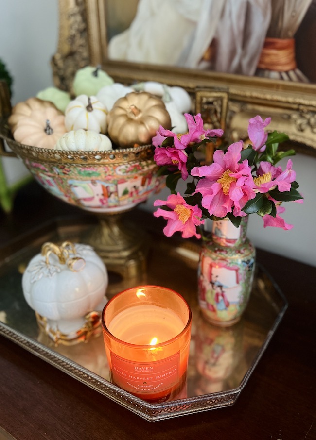 Pumpkin candle with pink camellias