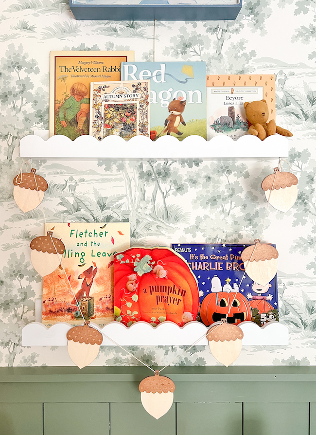Our fall story shelves for James decorated with acorn garland