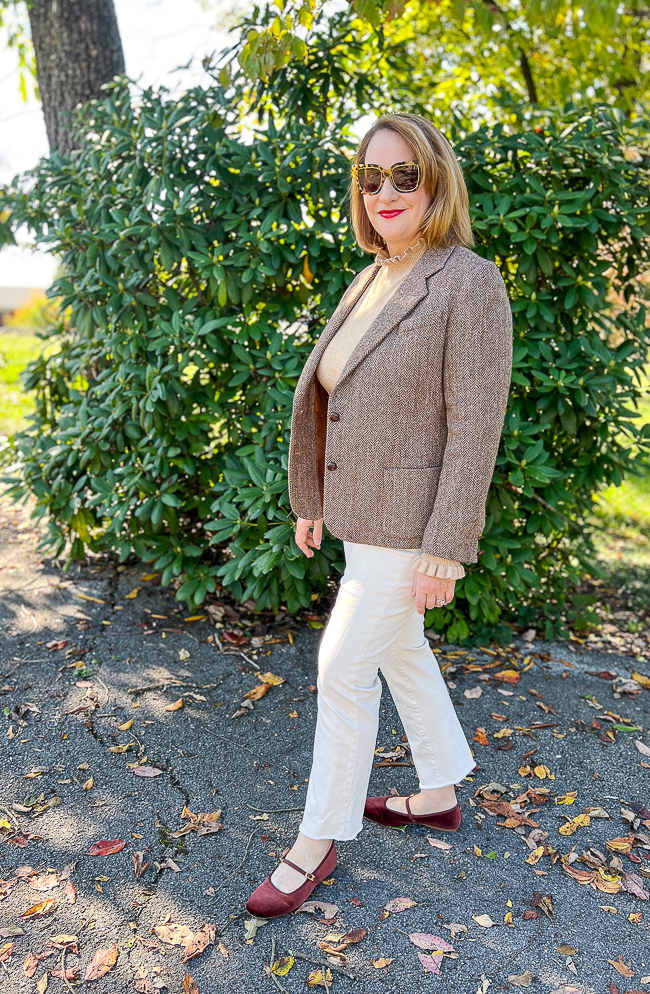Katherine in brown tweed blazer with ruffle turtleneck sweater, cream colored jeans, and brown velvet Mary Jane flats