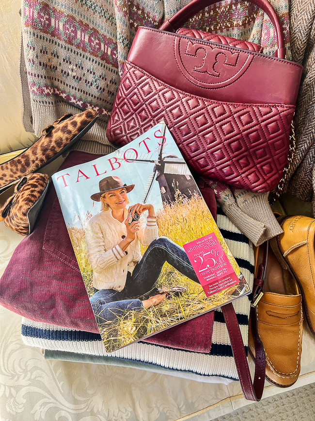 Talbots catalog on pile of fall clothes - using catalog to shop my own closet