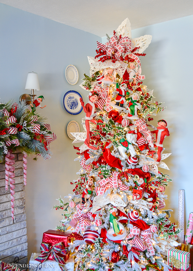 A red and white Christmas tree with candy cane stripes, giant snowflakes, and annalee dolls create this whimsical look!