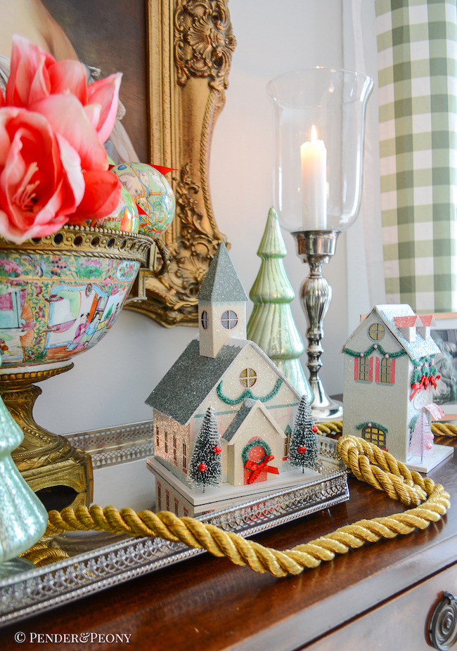 katherine's sideboard decorated with Christmas village houses, "12 days of Christmas" ornaments, amaryllis