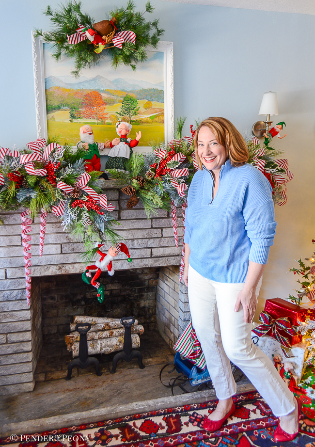red and white Christmas garland on stone mantel with candy cane striped ribbon and Annalee dolls