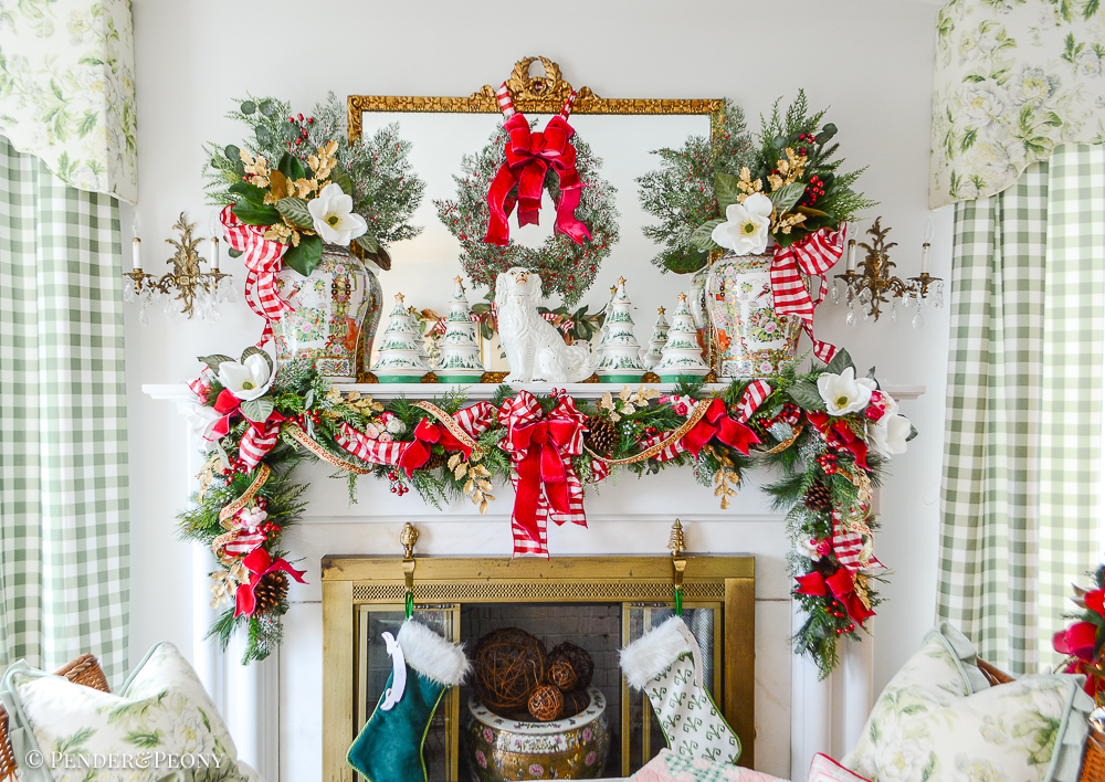 Katherine's formal living room mantel decorated with jolly blossoms Christmas decor: magnolia, holly, pink velvet, red gingham, Rose Medallion