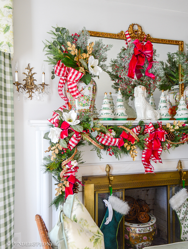 Rose Medallion temple jar holds winter botanical arrangement with magnolia, cedar, and gold holly