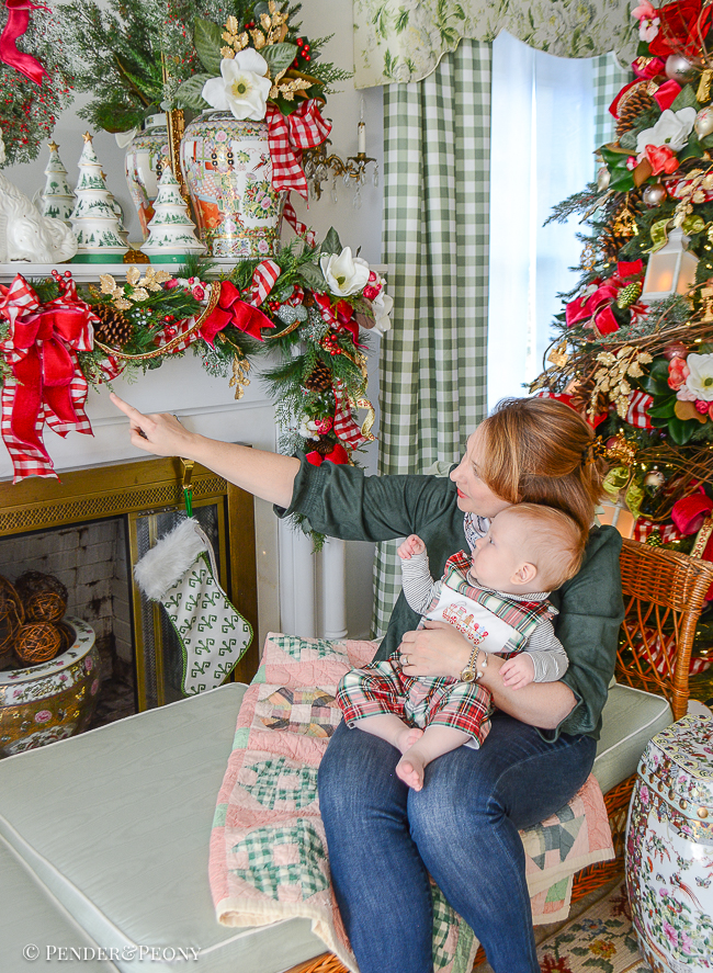 Katherine and baby James look at Jolly Blossoms Christmas garland
