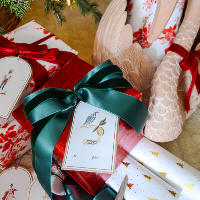 Red and green wrapped presents with "12 Days of Christmas" gift tags