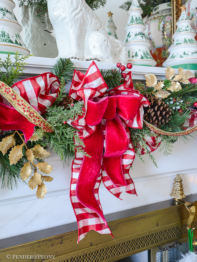 Garland is tied up with a red and white gingham and pink velvet bow