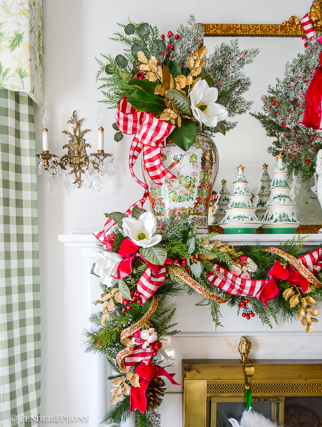 Rose Medallion temple jar holds winter botanical arrangement with magnolia, cedar, and gold holly