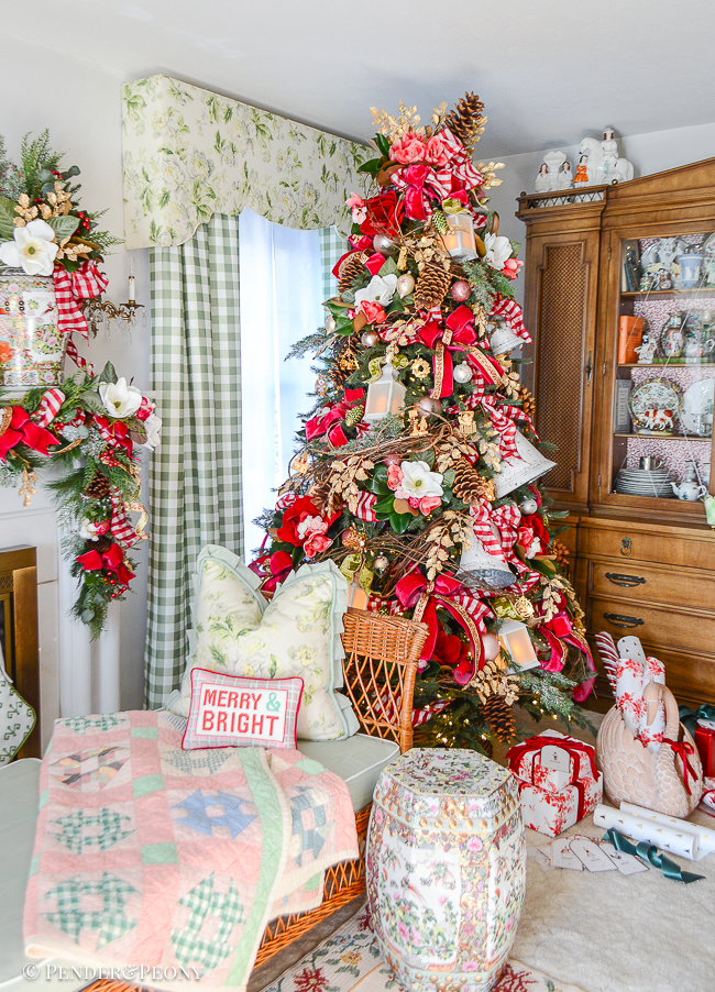 Jolly Blossoms Christmas tree - floral Christmas tree with magnolia, ranunculus, grapevine, bells, pink velvet bows, red gingham, and gold holly