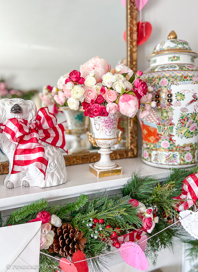 Pink and white ranunculus and peonies in an Old Paris urn