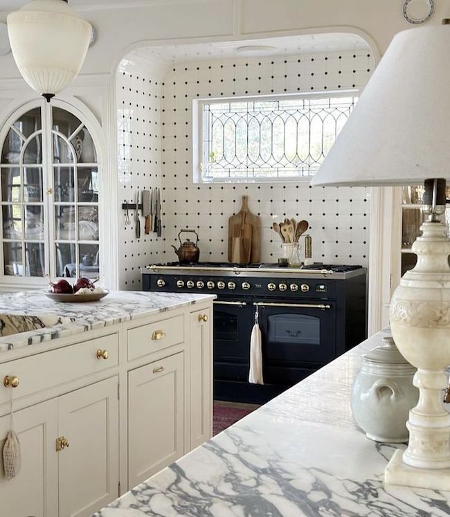 Black and white traditional kitchen with elaborate tile work