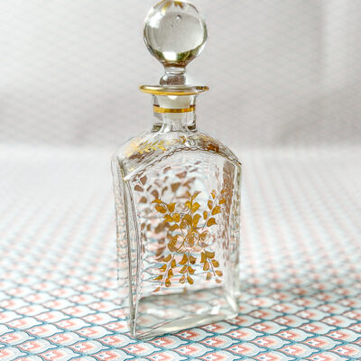 A chic French perfume bottle with gilt florals.
