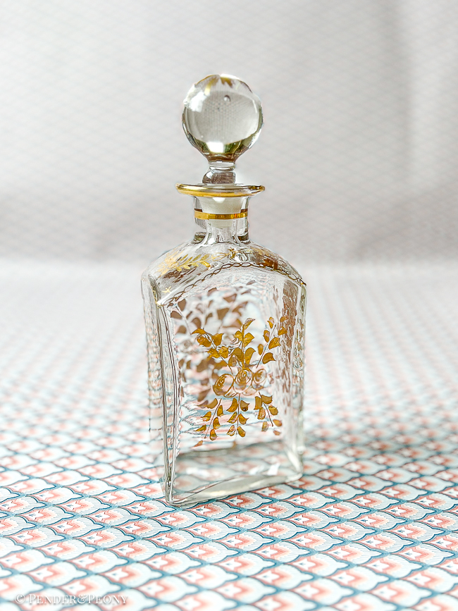 A chic French perfume bottle with gilt florals.