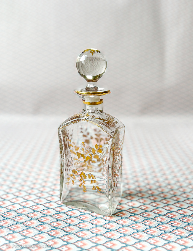 A chic French perfume bottle with gilt florals.