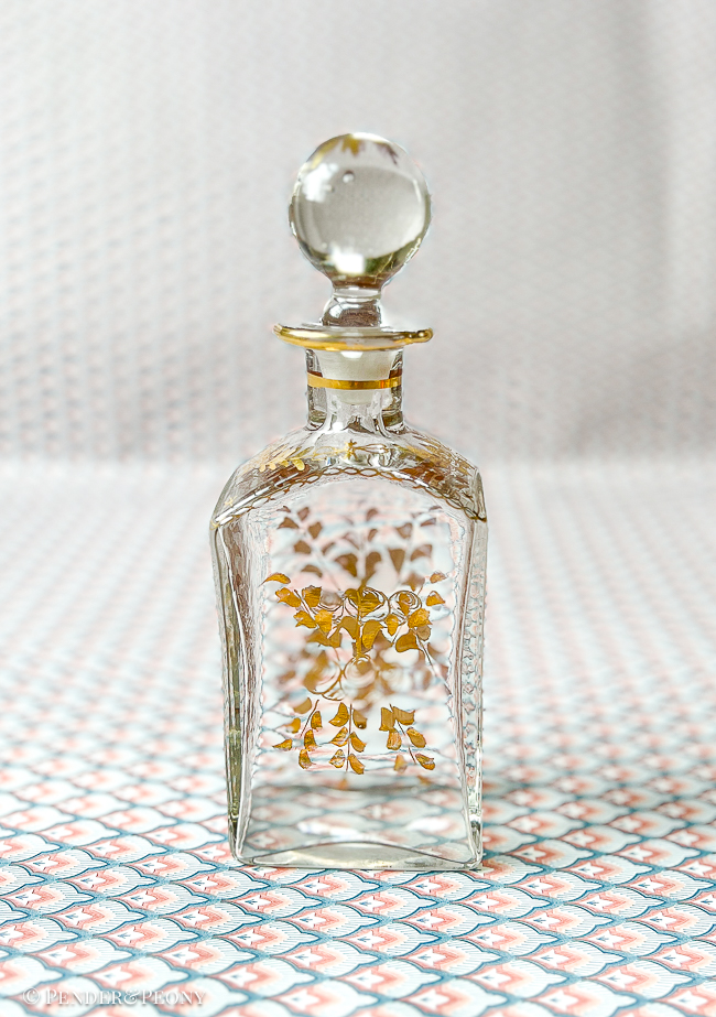 A chic French perfume bottle with gilt florals.