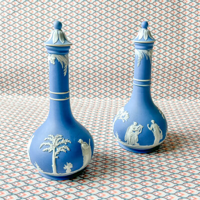 Classic blue and white Wedgwood Jasperware bottles with lids.