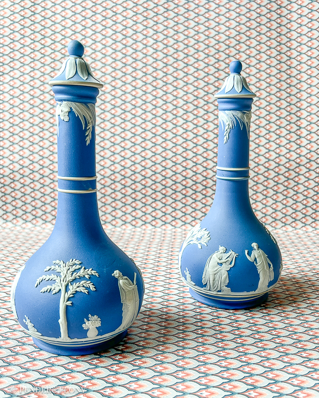Classic blue and white Wedgwood Jasperware bottles with lids.