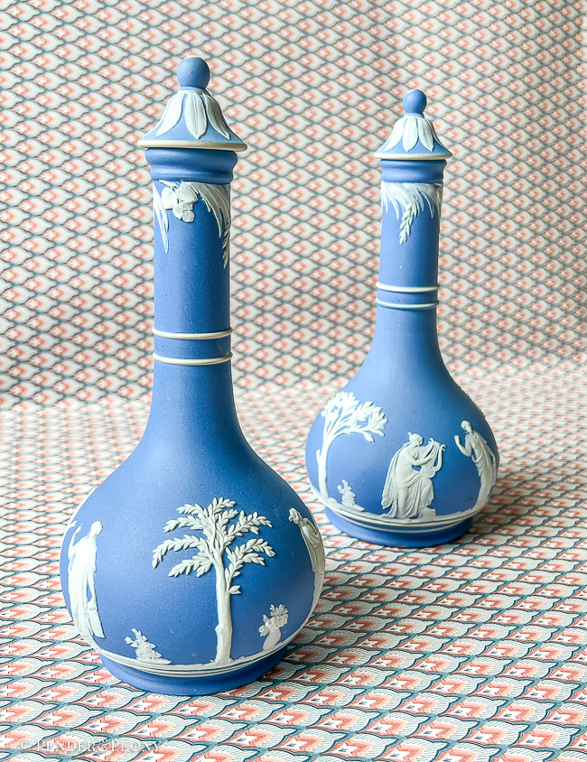 Classic blue and white Wedgwood Jasperware bottles with lids.
