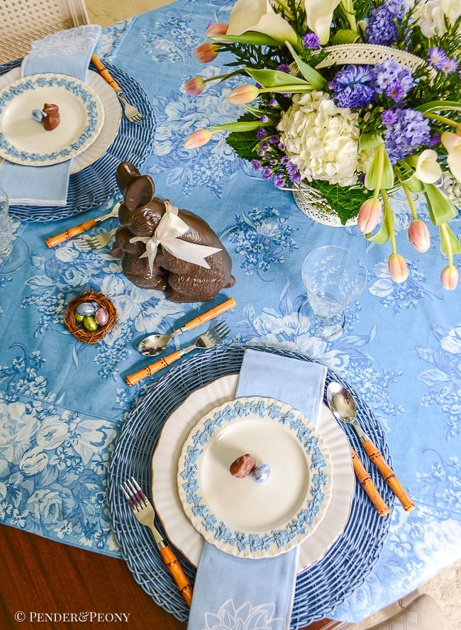 A top view of the place setting for this blue and white Easter table with Wedgwood Queen's Ware lavender on cream