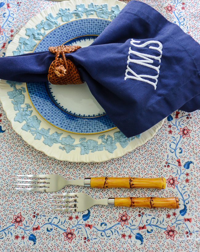 Monogrammed napkins, Mottahedeh blue lace, Wedgwood Queen's Ware, and floral placemats decorate this Independence Day tablescape.