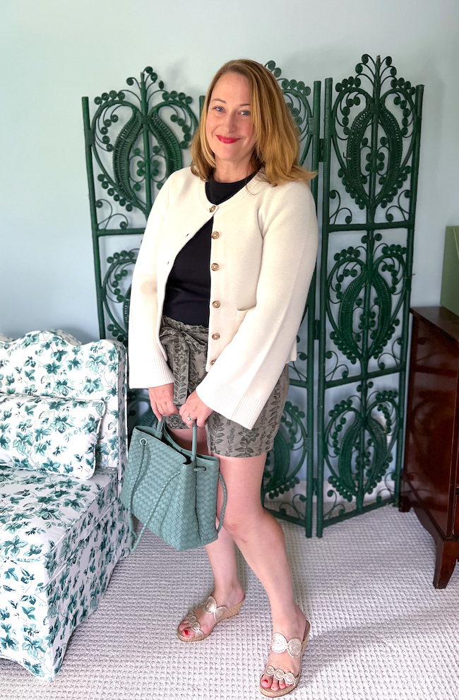 Katherine wearing ivory cashmere cardigan, shorts, espadrilles, and black t-shirt