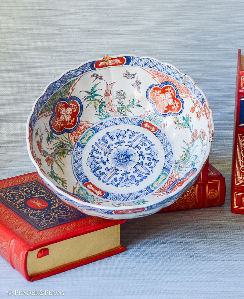 A unique Japanese Imari bowl with gilt repaired rim decorated with scenes of bamboo, birds, flowering trees, and lanterns.