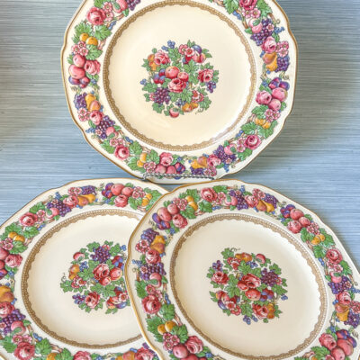 Florentine dinner plates from Crown Ducal: border features raised relief designs of fruit and flowers. Circa 1930s.