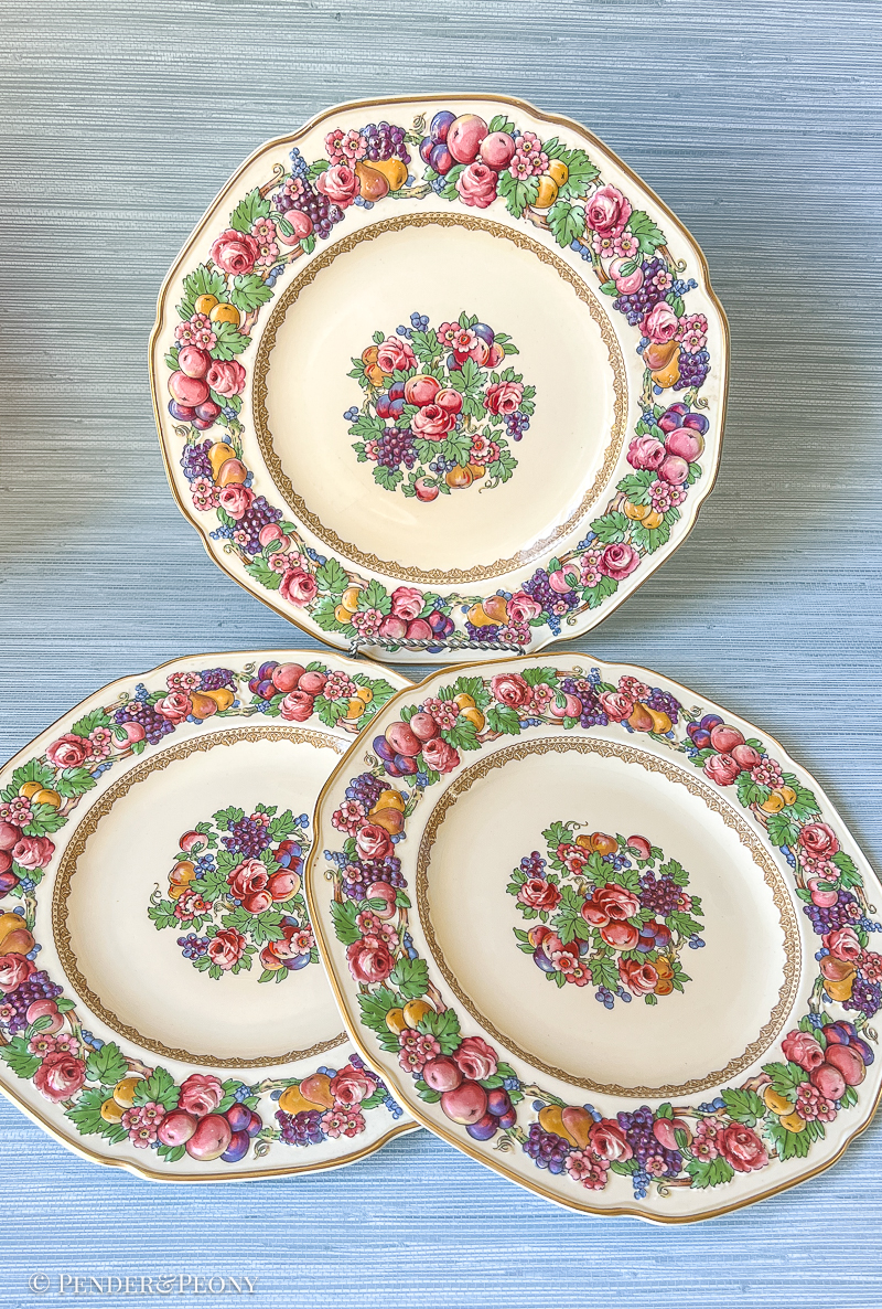Florentine dinner plates from Crown Ducal: border features raised relief designs of fruit and flowers. Circa 1930s.