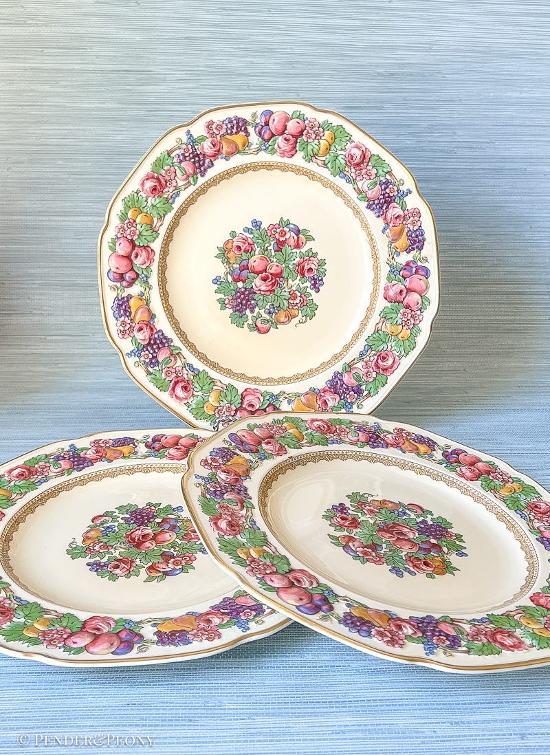 Florentine dinner plates from Crown Ducal: border features raised relief designs of fruit and flowers. Circa 1930s.