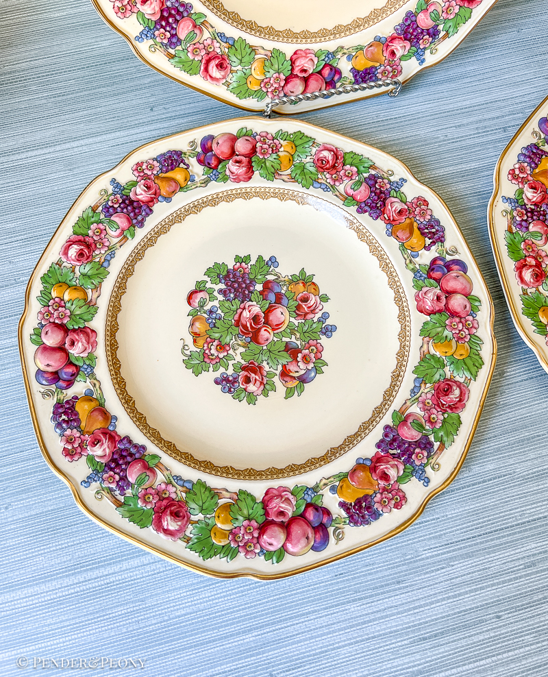 Florentine dinner plates from Crown Ducal: border features raised relief designs of fruit and flowers. Circa 1930s.