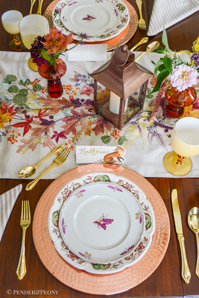 Vintage Royal Tettau oak and acorn motif salad plate on top of a Johnson Bros transferware dinner on top of a hammered copper charger.