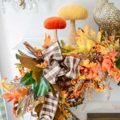 Velvet mushrooms perch above a tumbling fall garland of oak, magnolia, fern, and bittersweet.