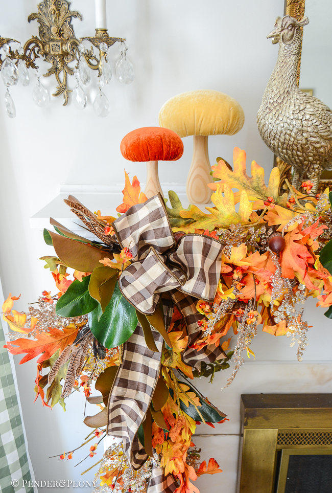 Velvet mushrooms perch above a tumbling fall garland of oak, magnolia, fern, and bittersweet.