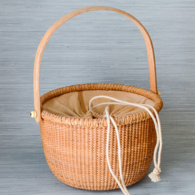 A New England classic basket with handle and cloth lining.
